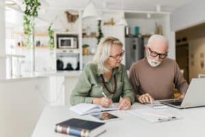 Senior couple using laptop while planning their retirement