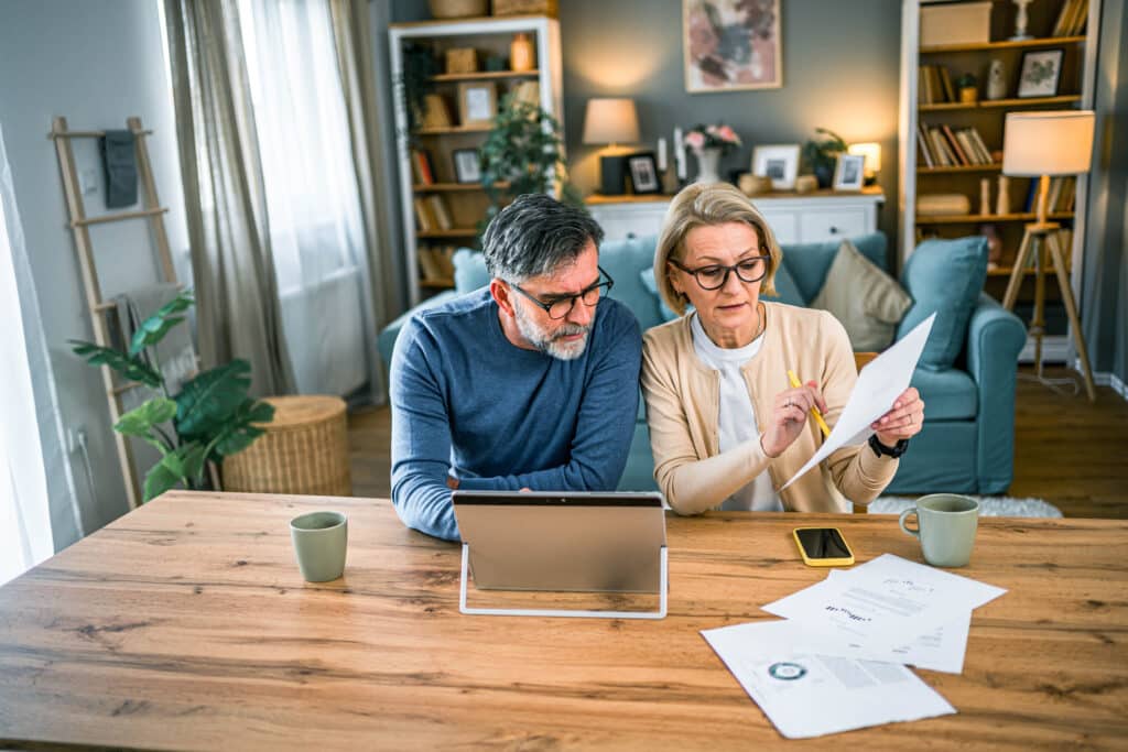 Mature couple manages retirement expenses and bills