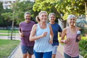 Senior healthy group jogging together at park